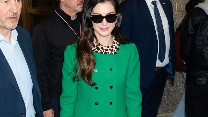 Image may contain Anne Hathaway Jorge Furtado Clothing Coat Person Adult Accessories Glasses Overcoat and Jeans