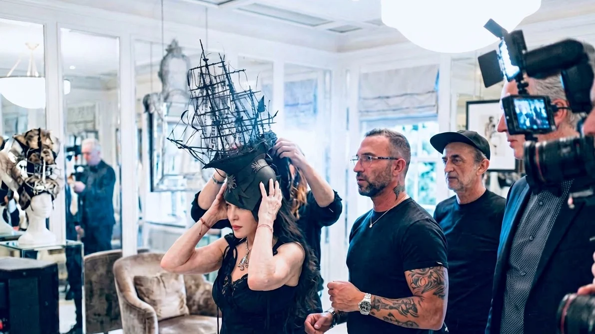 Image may contain Madonna Person Photobombing Adult People Urban Wedding Face Head Accessories and Jewelry