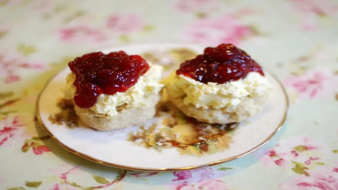 Scones with jam and cream on a plate