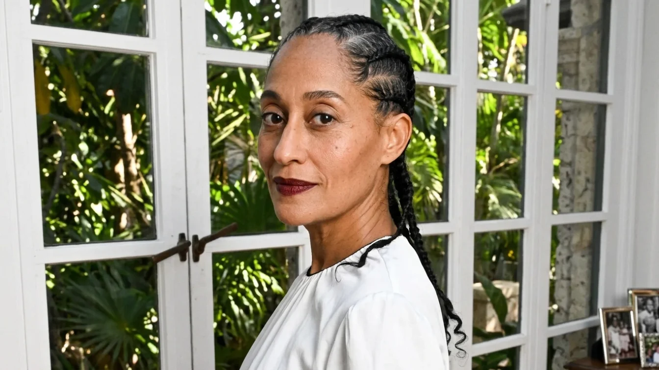 Tracee Ellis Ross wears an allwhite outfit and dark lipstick.