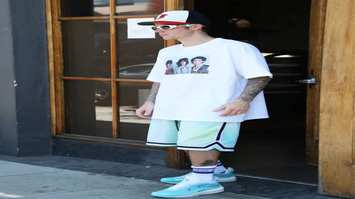 Image may contain Pierre Rolland Kevin Jonas L.P. Clothing TShirt Shorts Sleeve Beachwear Person Teen and Skin