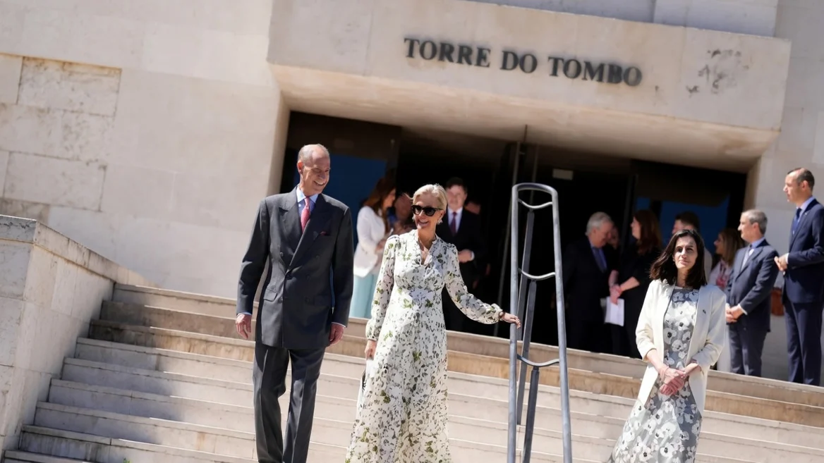 Duchess Edinburgh in a white floral dress and sunglasses walking down steps with Prince Edward