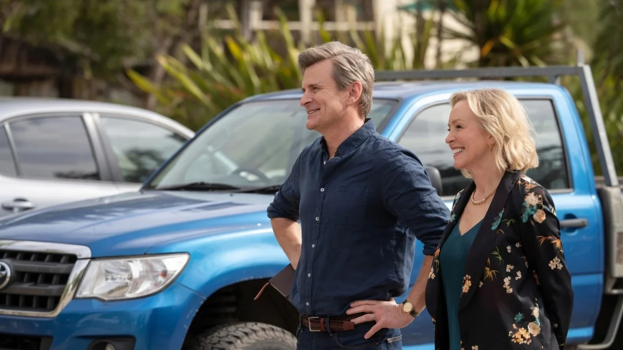 man and woman standing in front of truck