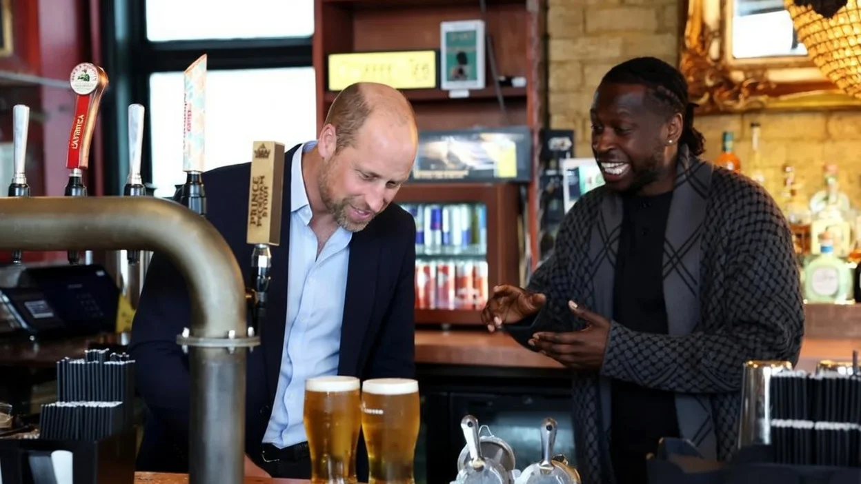 Britain's Prince William, Prince of Wales reacts after pulling a pint beside pub founder Clement Ogbonnaya as he visits The Prince of Peckham Pub in Peckham, south east London on June 3, 2026